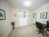 Bright and inviting home office with stylish decor, framed art, and a large window for natural light.