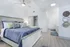 Charming bedroom with elegant decor, featuring a cozy bed, stylish pillows, and soothing neutral tones.