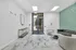 Chic apartment lobby with modern decor, featuring a stylish tiled floor, elegant furniture, and unique green accent wall.