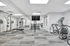 Bright and modern fitness center featuring state-of-the-art exercise equipment, including treadmills, weight machines, and dumbbells, ideal for a healthy lifestyle.