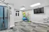 Modern apartment gym with state-of-the-art equipment, exercise balls, and a flat-screen TV, perfect for fitness enthusiasts.