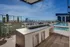 Breathtaking rooftop terrace with panoramic city views, featuring modern outdoor seating and a luxurious swimming pool.