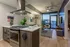 Modern open-concept apartment with sleek kitchen island, inviting living area, and floor-to-ceiling windows with panoramic city views.