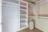 Spacious walk-in closet featuring sleek shelving and ample hanging space, perfect for organizing your wardrobe.