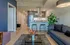 Contemporary open-concept apartment interior with sleek kitchen, stylish living area, and modern décor.