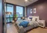 Elegant bedroom with a city view, featuring chic decor, cozy bedding, and modern furnishings.