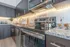 Modern kitchen with sleek stainless steel appliances, granite countertops, and elegant cabinetry, accented by under-cabinet lighting and chic decor.