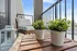 Charming balcony with cozy seating, potted plants, and serene views, perfect for relaxation.