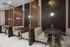 Chic dining area with elegant wood paneling, plush seating, and stylish geometric partitions.