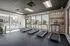 Bright and modern fitness center with treadmills, motivational wall art, and a view of the outdoor pool area.