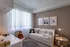 Cozy and inviting children's room with plush toys, soft lighting, and decor in neutral tones.