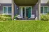 Charming apartment patio with cozy outdoor seating, lush greenery, and a serene garden view.