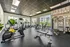 Modern fitness center with state-of-the-art gym equipment, bright windows, and motivational wall art.