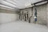 Modern apartment bike storage room featuring wall-mounted bicycle racks and sleek concrete walls.