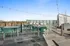 Inviting rooftop terrace with sleek outdoor seating, string lights, and panoramic views, perfect for relaxing and entertaining.