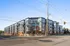 Modern apartment building with a sleek design, large windows, and inviting balconies, now open for residents.