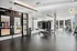 Modern fitness center with sleek equipment, mirrored walls, and large windows offering natural light.