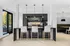 Chic and modern kitchen with elegant black backsplash, stylish pendant lighting, and a cozy seating area, perfect for entertaining.