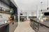 Luxurious modern kitchen with sleek black countertops, stylish pendant lighting, and built-in seating, perfect for entertaining.