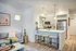 Modern apartment interior with cozy living room and sleek kitchen featuring stainless steel appliances and a stylish breakfast bar.