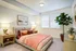 Bright and inviting bedroom with modern decor, cozy bed, stylish side tables, soft lighting, and lush indoor plants creating a serene atmosphere.