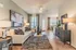Inviting open-plan living area with stylish decor, cozy seating, and natural light-filled dining space.