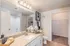 Elegant bathroom featuring a luxurious marble countertop, modern decor, and spacious walk-in closet.