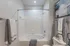 Elegant bathroom showcasing a pristine white bathtub, modern fixtures, and plush towels, creating a relaxing atmosphere.