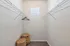 Spacious and bright walk-in closet with wire shelving and natural light, perfect for stylish storage solutions.