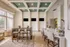 Elegant community room with modern decor, featuring ample seating, natural light from large windows, and contemporary ceiling design.