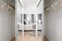 Modern bedroom with mirrored closet doors, stylish decor, and bright ambiance reflecting cozy elegance.