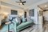 Modern apartment living area with stylish green sofa, cozy bedroom setup, and elegant decor.