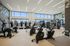 Modern fitness center with state-of-the-art gym equipment and large windows offering panoramic city views.