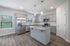 unfurnished kitchen area with island in home