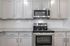 unfurnished kitchen area with countertops and stove in home
