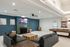Resident lounge with modern seating, a fireplace feature wall, wall-mounted TV, and a pool table in a bright, open space.
