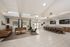 Spacious resident lounge with high ceilings, modern seating areas, a bar-style counter, flat screen TV's, and natural light from large windows.