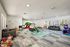 Indoor children&rsquo;s playroom with colorful toys, climbing and slide structures, soft play mats, and seating in a bright, open space.
