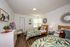 Secondary bedroom with two beds, playful decor, natural light, and neutral finishes in a comfortable layout.