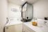 In-home laundry room with full sized washer and dryer, built-in shelving, and dedicated utility space.