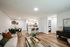 Open-concept apartment home featuring a living area, dining space, and kitchen with a breakfast bar, modern finishes, and wood-style flooring.