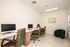 Cyber co-working lounge with desktop workstations, comfortable seating, and a quiet, modern workspace.