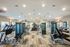 Modern fitness center featuring state-of-the-art weight machines and vibrant workout equipment in a well-lit, spacious room.