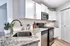 Modern kitchen with sleek stainless steel appliances, granite countertops, and ample white cabinetry creating a bright and inviting space.
