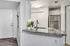 Modern kitchen with sleek stainless steel appliances, stylish countertop, and elegant dining area in view.
