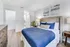 elegant bedroom with hardwood floors showing en suite bathroom