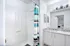 spacious modern bathroom with granite countertops and large shower