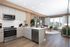 Kitchen with GE stainless steel appliance package with view of living area