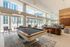 Lounge area with modern pool table, ample seating, and full-height windows.
