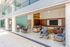 Modern lounge with rocking chairs, armchairs, a large TV, and contemporary decor.